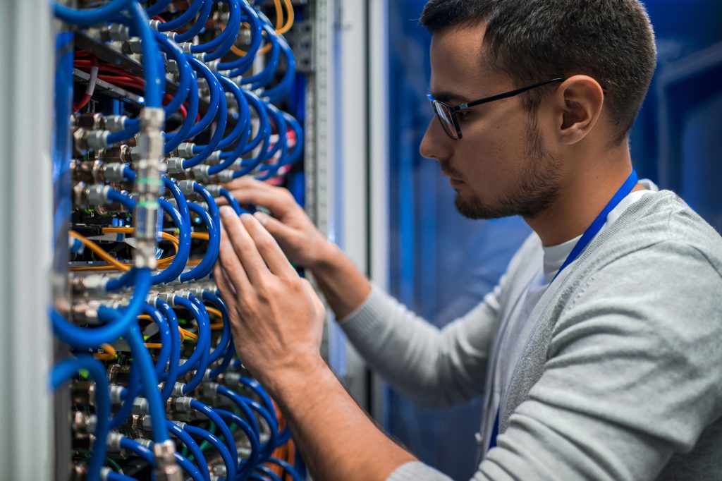 Service technician at cabling panel